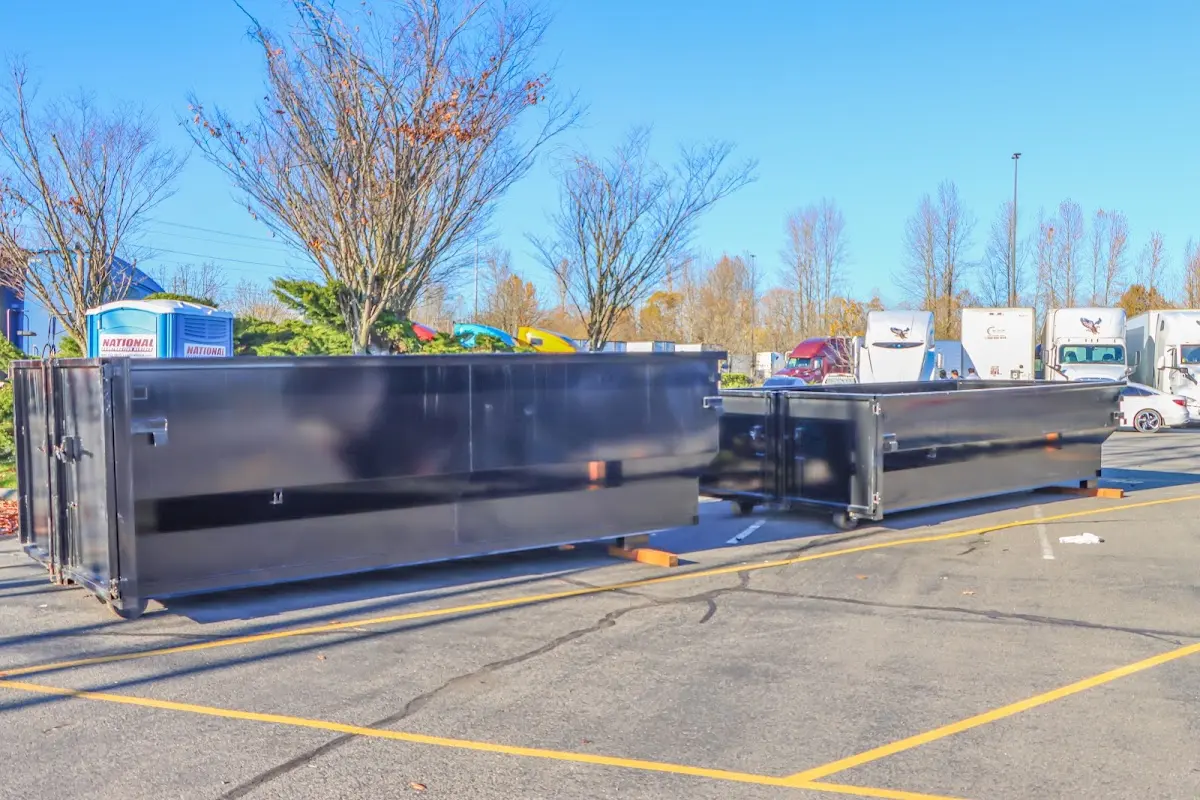 Professional dumpster rental service with roll-off container on residential driveway in Irondale